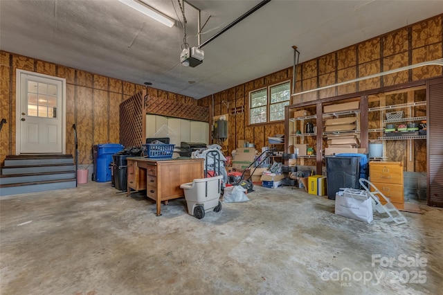 garage featuring wooden walls and a garage door opener