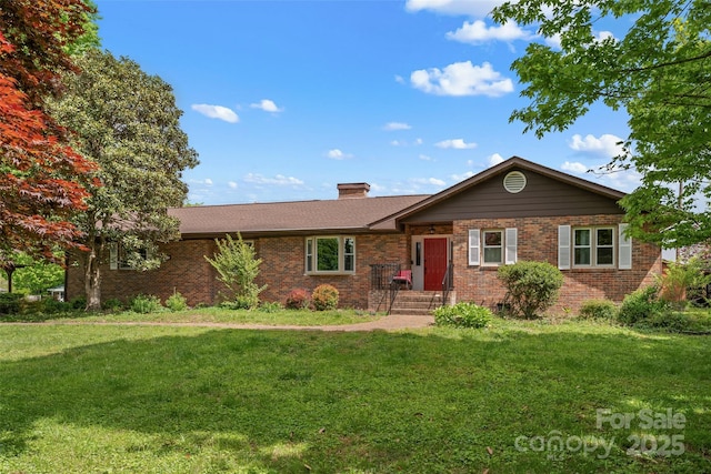 ranch-style house with a front lawn, a chimney, and brick siding