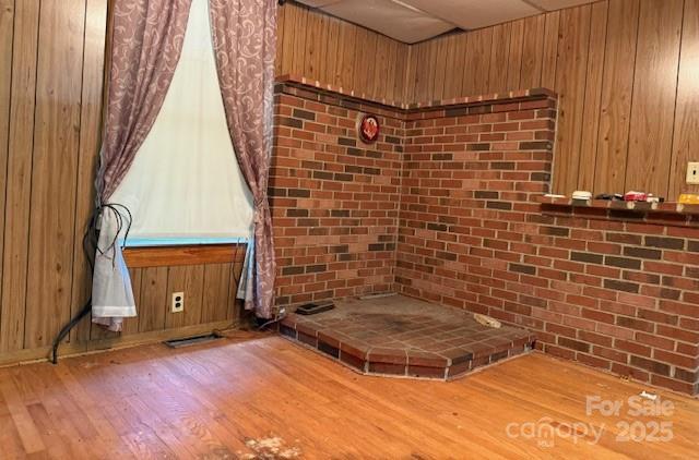 interior space with wood walls and wood finished floors