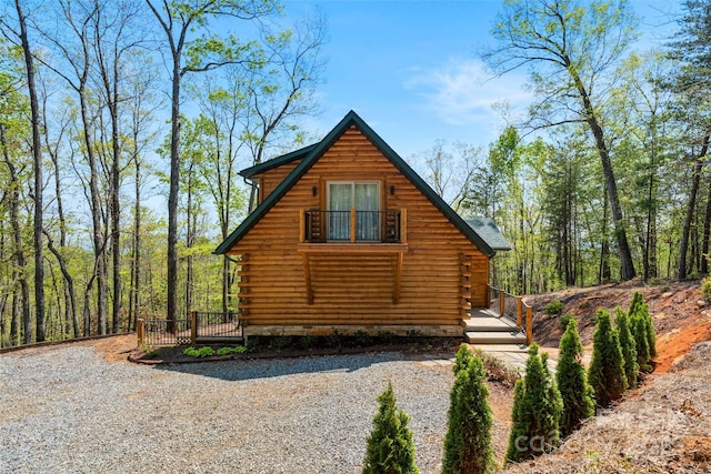 view of property exterior featuring log siding