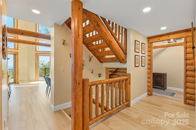staircase with baseboards, recessed lighting, and wood finished floors