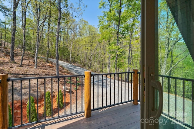 balcony featuring a view of trees