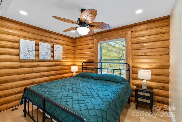 bedroom featuring light wood-type flooring, recessed lighting, and rustic walls