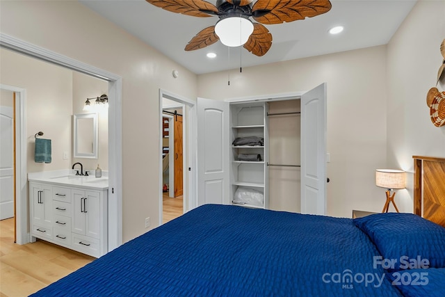 bedroom with a closet, recessed lighting, and light wood-type flooring