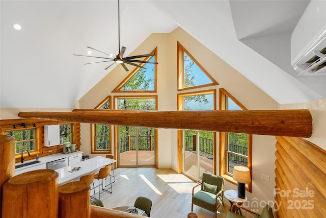 153 Chetan Way, Lake Lure, NC 28746 - living room with light wood finished floors, ceiling fan, a wealth of natural light, and high vaulted ceiling