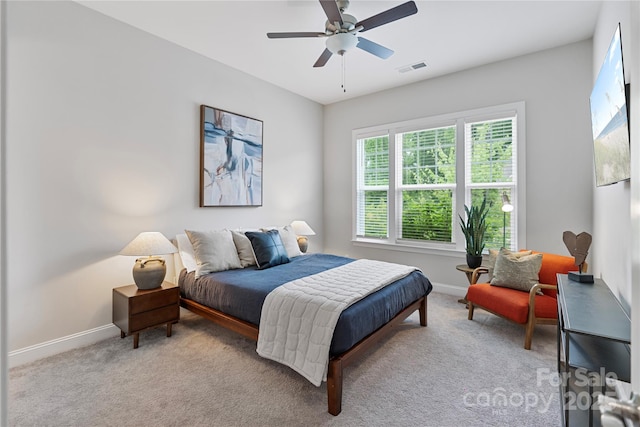 bedroom with baseboards, a ceiling fan, carpet flooring, and visible vents