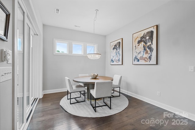 dining space with visible vents, dark wood-style flooring, and baseboards