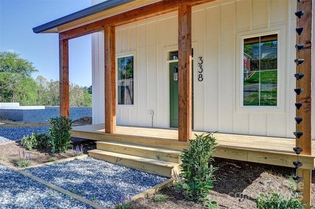 entrance to property with board and batten siding and covered porch