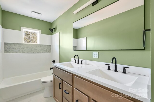 bathroom with a sink, tile patterned floors, bathtub / shower combination, and toilet