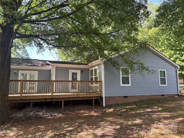 back of property featuring french doors, crawl space, and a wooden deck