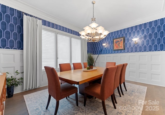 2915 Cutter Ct, Waxhaw, NC 28173 - dining space with wallpapered walls, crown molding, a decorative wall, a chandelier, and a wainscoted wall