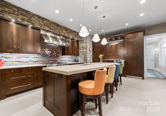2915 Cutter Ct, Waxhaw, NC 28173 - bar area with wall chimney exhaust hood, a sink, tasteful backsplash, hanging light fixtures, and recessed lighting