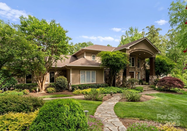 2915 Cutter Ct, Waxhaw, NC 28173 - view of front of house featuring a front yard, stone siding, and a shingled roof