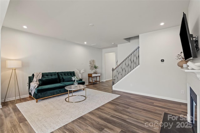 15622 Little Bluestem St, Charlotte, NC 28278 - living room with stairs, dark wood-type flooring, recessed lighting, baseboards, and a glass covered fireplace