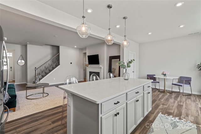 15622 Little Bluestem St, Charlotte, NC 28278 - kitchen featuring dark wood-style floors, baseboards, recessed lighting, light countertops, and a kitchen island