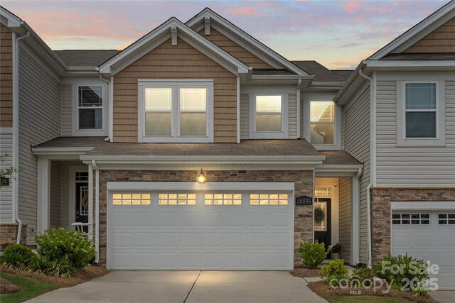 15622 Little Bluestem St, Charlotte, NC 28278 - townhome / multi-family property with driveway, a garage, stone siding, and a shingled roof