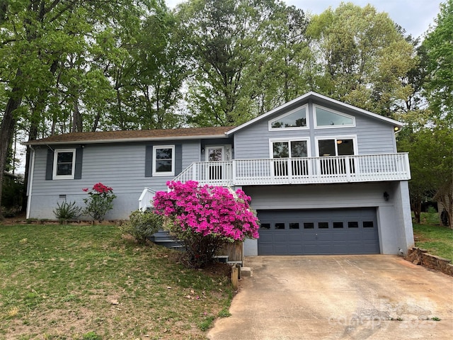 view of front of home featuring a front yard, driveway, crawl space, and an attached garage