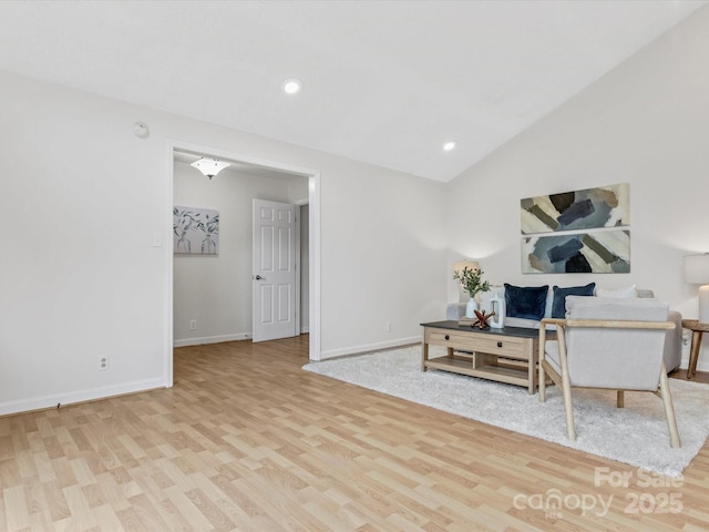 living area with wood finished floors, recessed lighting, vaulted ceiling, and baseboards