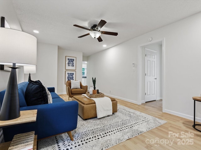 living room featuring recessed lighting, ceiling fan, wood finished floors, and baseboards