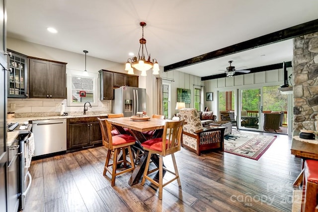 dining area with recessed lighting, ceiling fan, dark wood finished floors, and beam ceiling