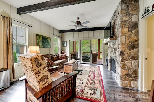 living room featuring a ceiling fan, wood finished floors, and a healthy amount of sunlight