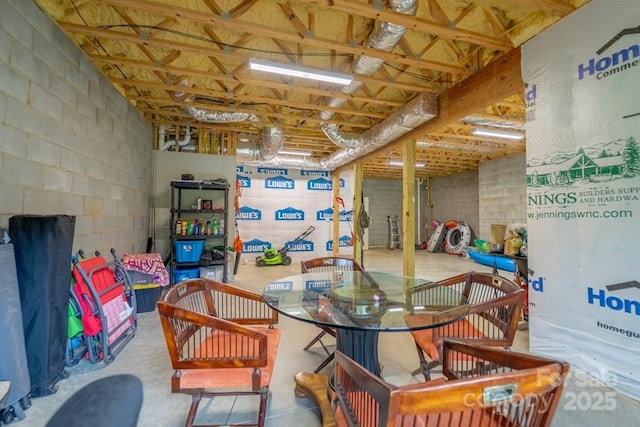 interior space featuring concrete block wall and concrete floors