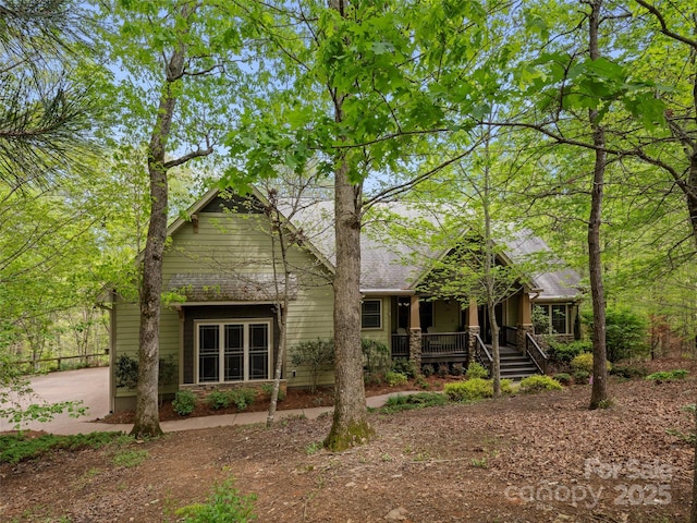 rear view of house featuring covered porch