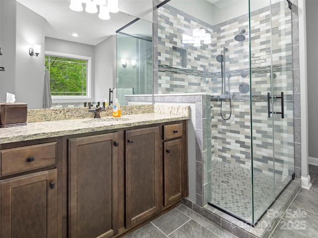 full bath featuring a shower stall, tile patterned flooring, and vanity
