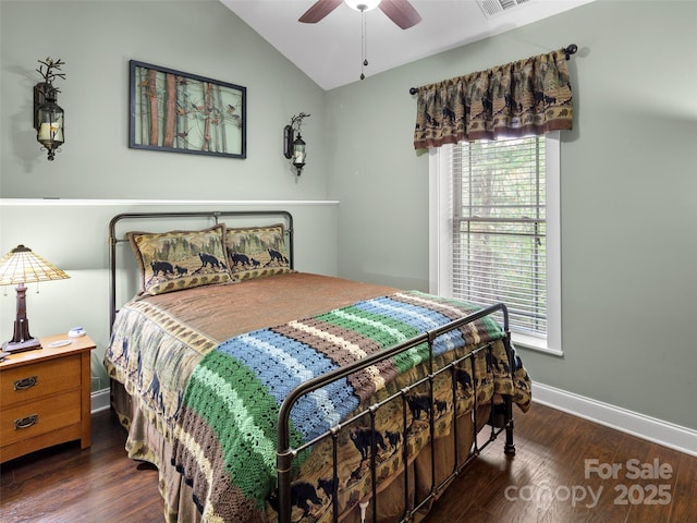 bedroom featuring wood finished floors, vaulted ceiling, baseboards, visible vents, and a ceiling fan