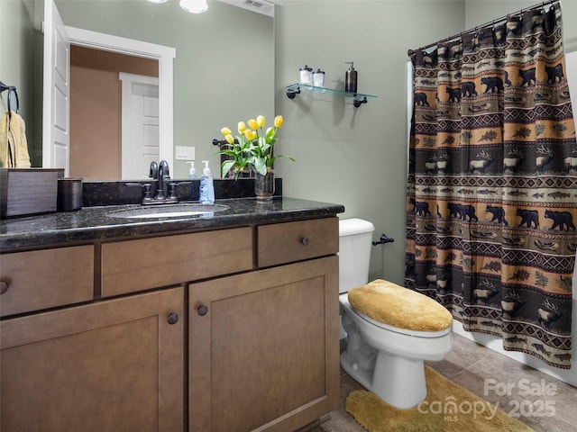 bathroom with toilet, tile patterned floors, a shower with curtain, and vanity