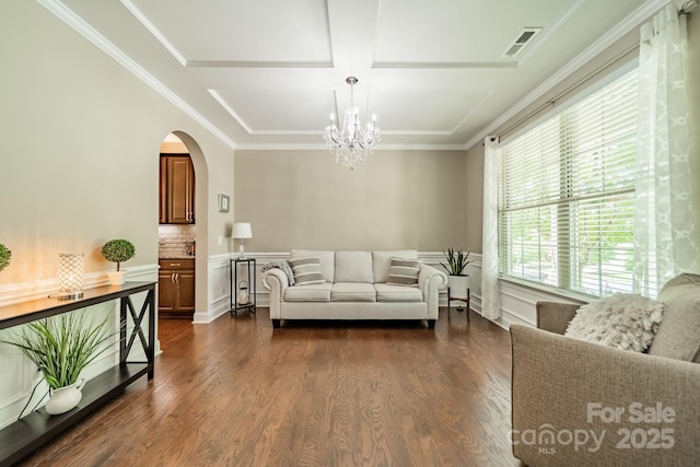 16507 Palisades Commons Dr, Charlotte, NC 28278 - living area featuring a chandelier, arched walkways, dark wood finished floors, and crown molding