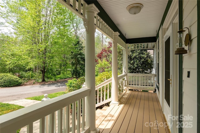 wooden terrace featuring covered porch