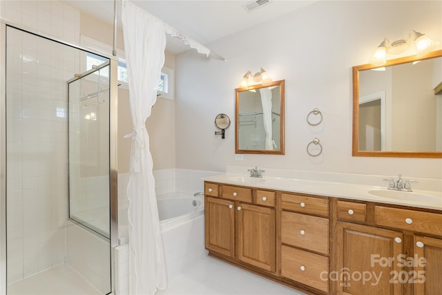 bathroom with a sink, a bath, tiled shower, and visible vents