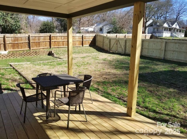 deck featuring a yard, outdoor dining space, and a fenced backyard