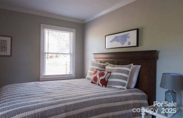 bedroom featuring crown molding and multiple windows