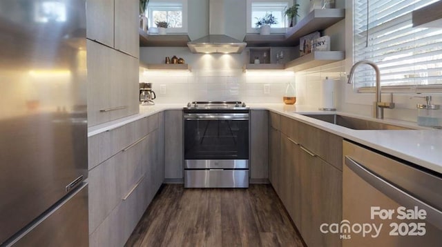 kitchen with open shelves, modern cabinets, a sink, wall chimney exhaust hood, and appliances with stainless steel finishes