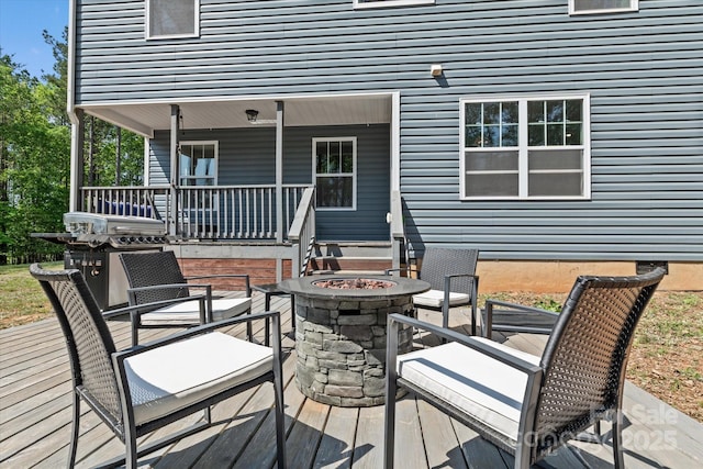 wooden terrace with a fire pit