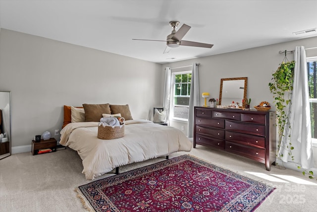 bedroom featuring carpet, a ceiling fan, and visible vents