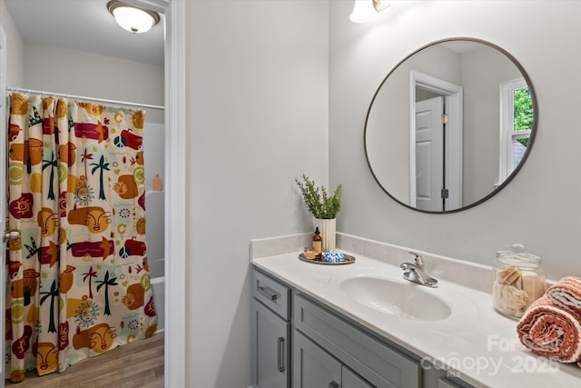 full bath featuring vanity and wood finished floors