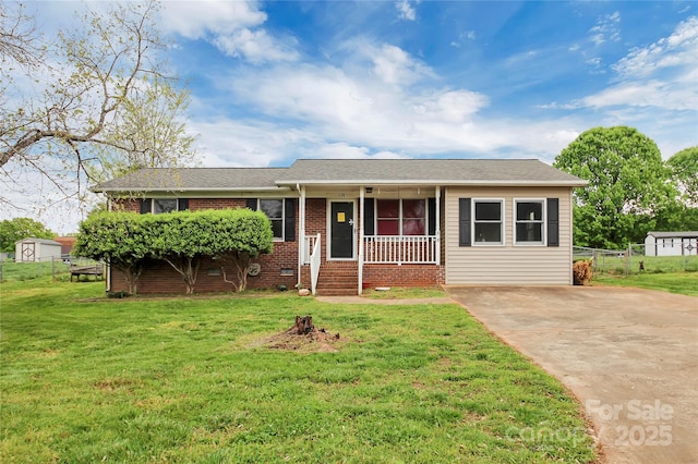 ranch-style home featuring a porch, a front lawn, driveway, and brick siding