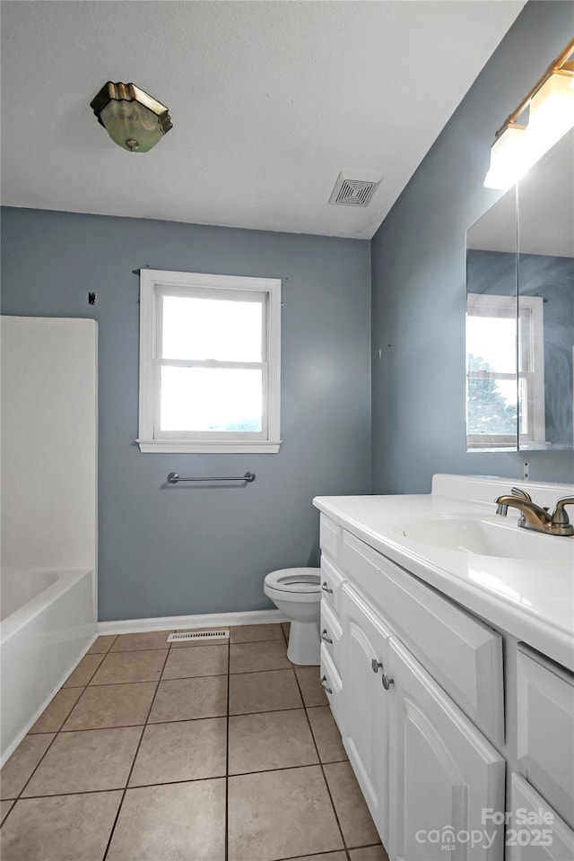 full bath featuring tile patterned flooring, toilet, a bath, vanity, and visible vents