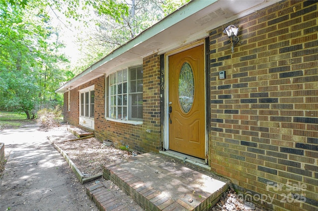 property entrance with brick siding