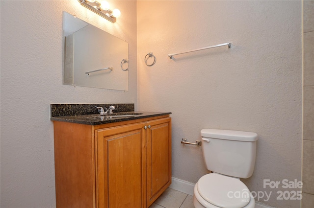 bathroom with vanity, toilet, and tile patterned floors