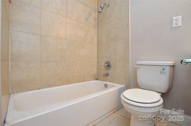 full bath with toilet, bathtub / shower combination, and a textured wall