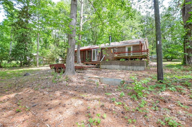 exterior space featuring a wooden deck and a sunroom