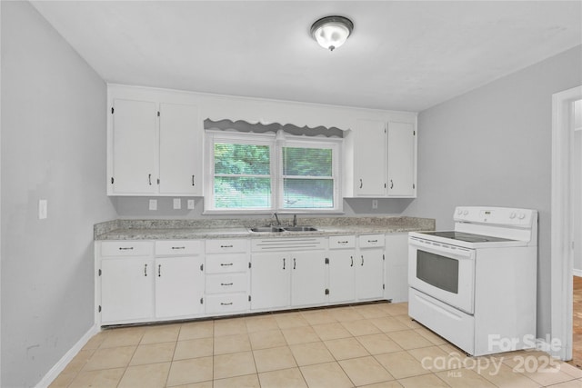 kitchen with a sink, light countertops, white cabinets, and electric range