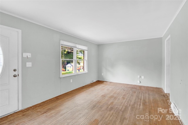 foyer with crown molding and hardwood / wood-style floors