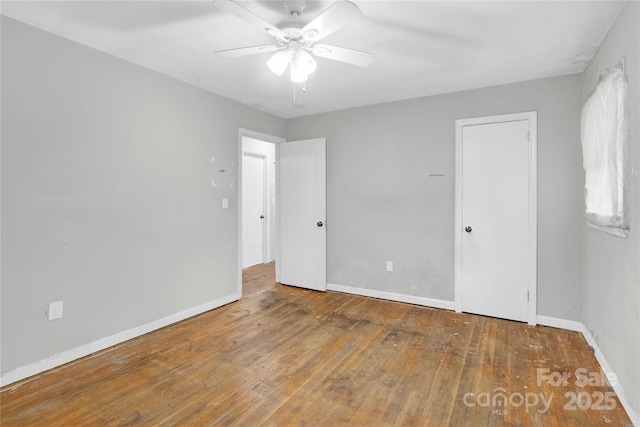 unfurnished bedroom with baseboards, a ceiling fan, and wood-type flooring