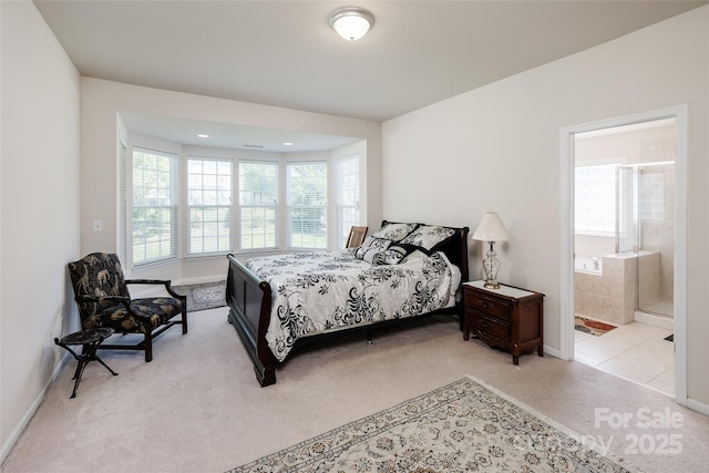 bedroom with baseboards, carpet flooring, and connected bathroom
