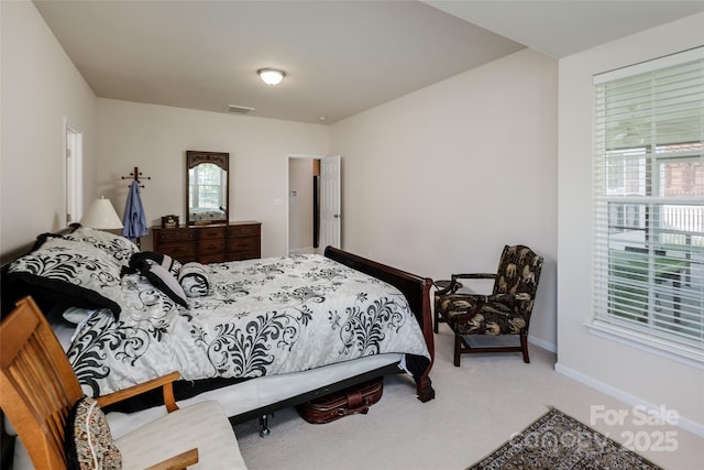 carpeted bedroom with visible vents and baseboards